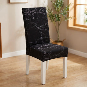 Housse de chaise extensible imprimée marbre noir posée sur une chaise de salle à manger