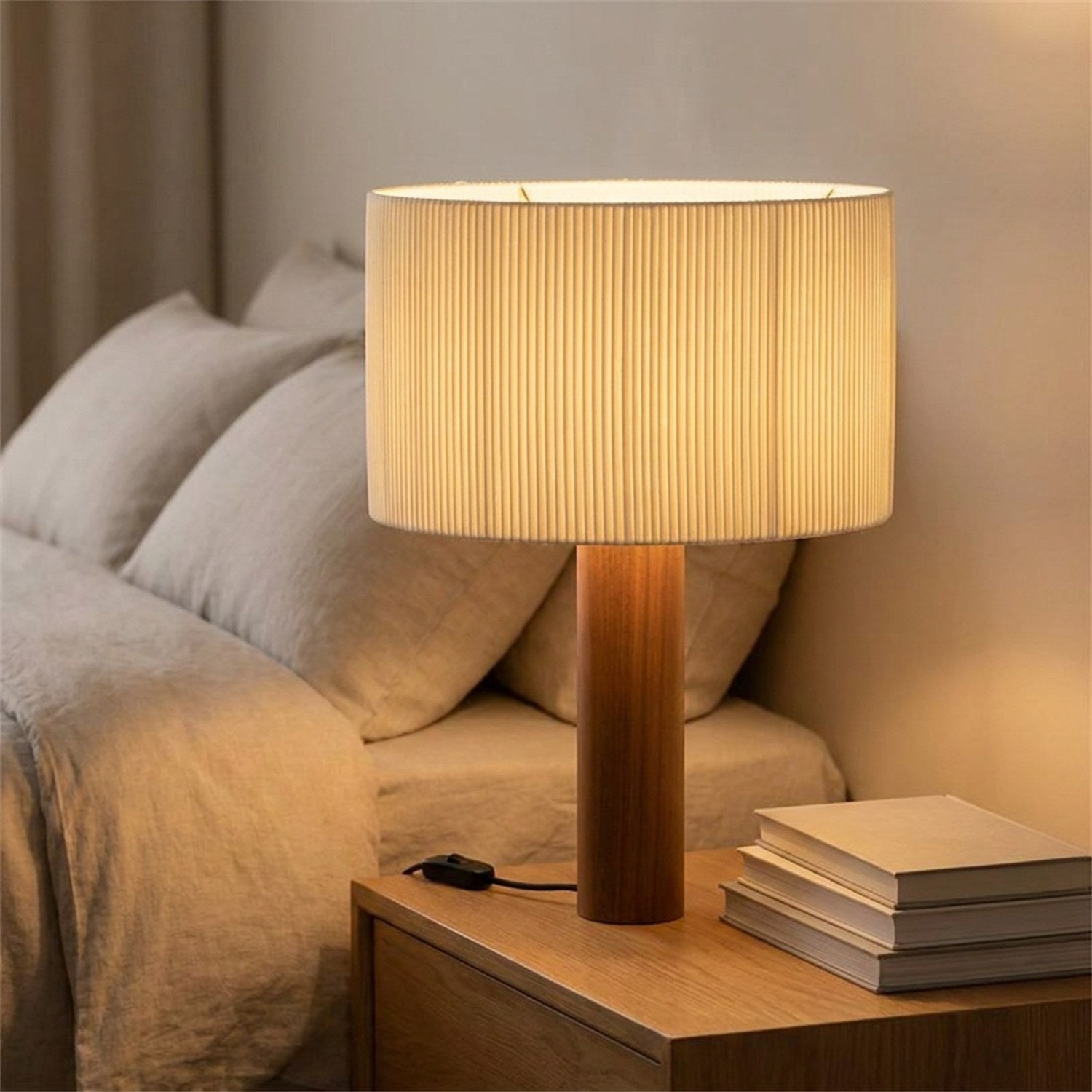 Lampe de table en bois avec abat-jour plissé sur une table de chevet dans une chambre chaleureuse