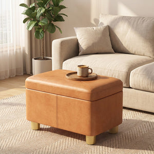 Pouf coffre de rangement utilisé comme repose-pieds au salon