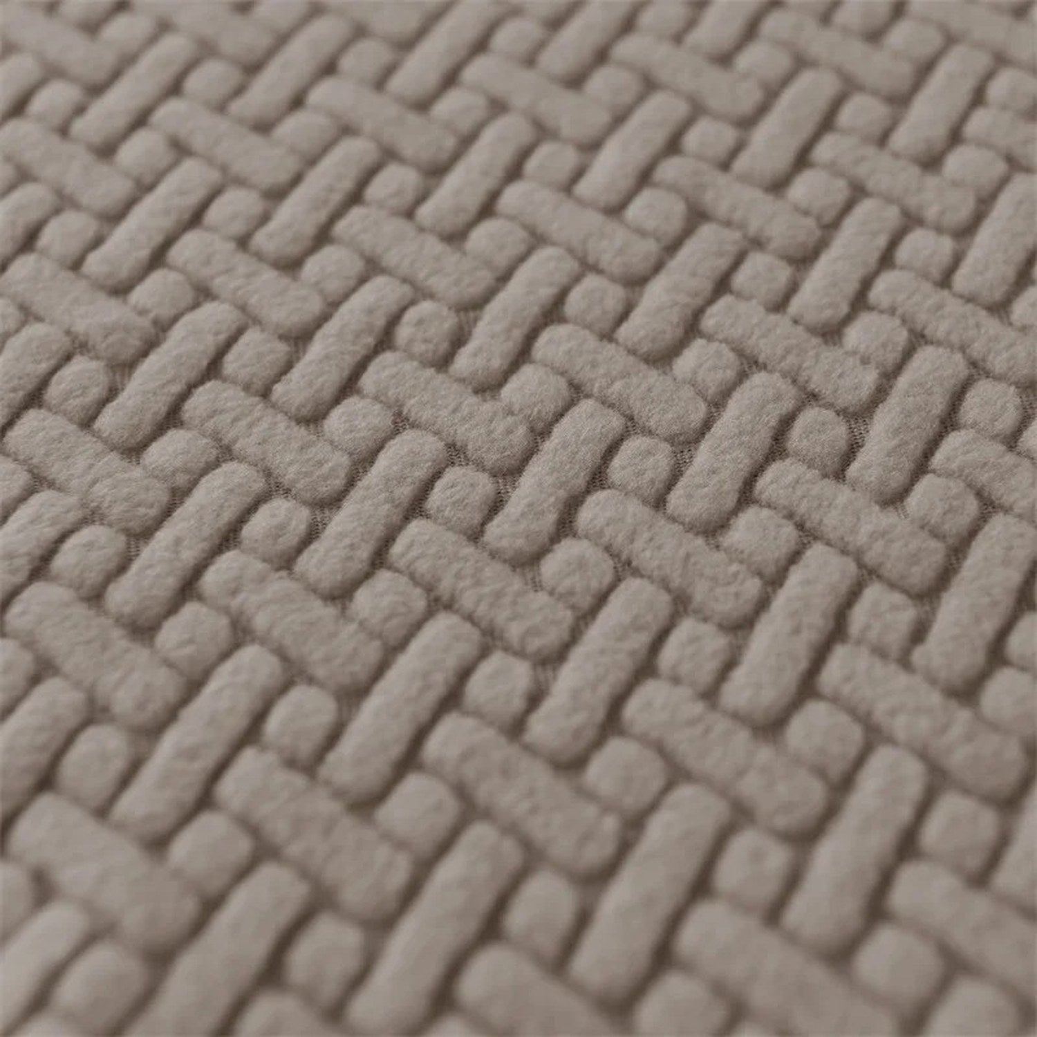 Gros plan sur la texture jacquard entrelacée de la housse de fauteuil