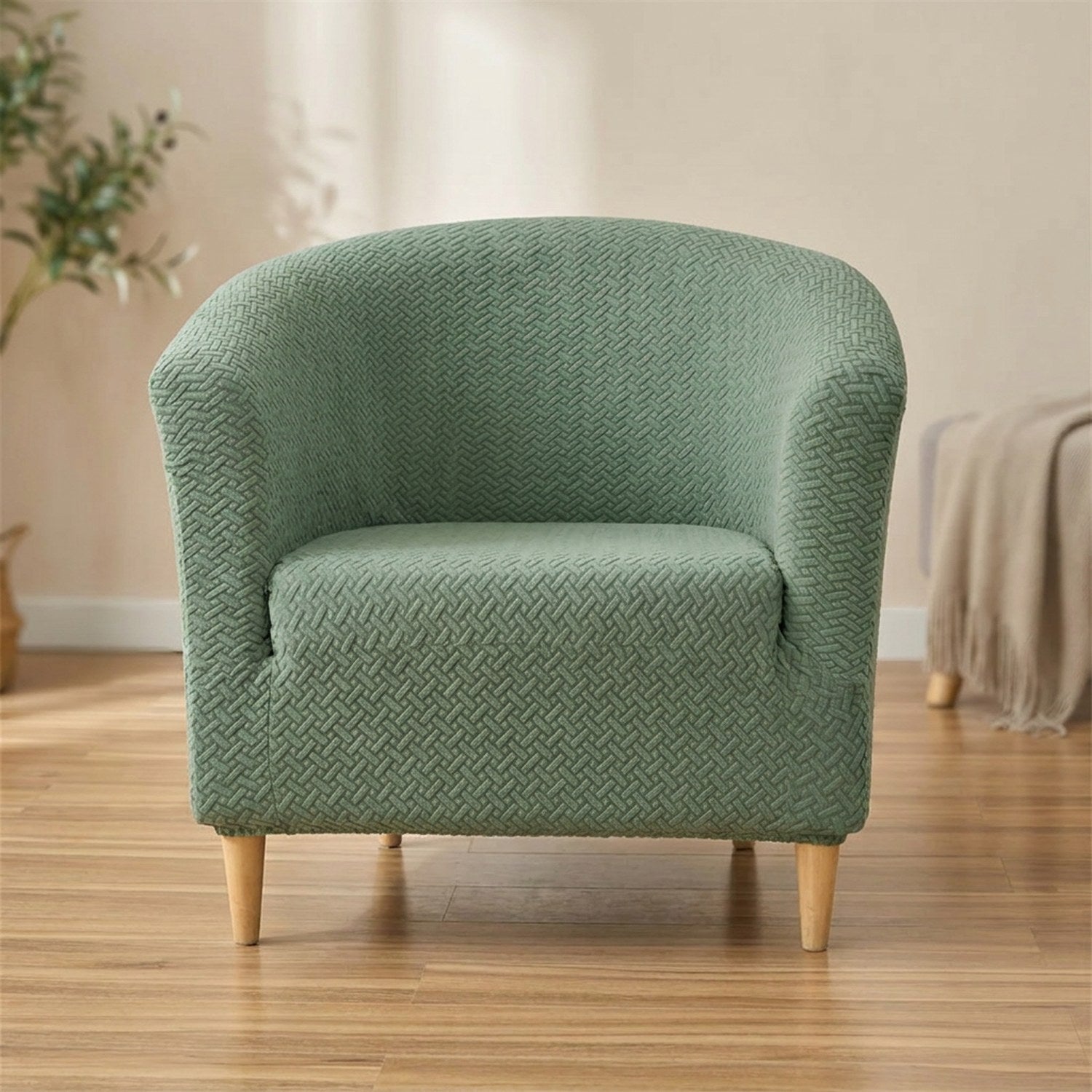 Housse de fauteuil club en jacquard texturé vert sauge sur un fauteuil cabriolet