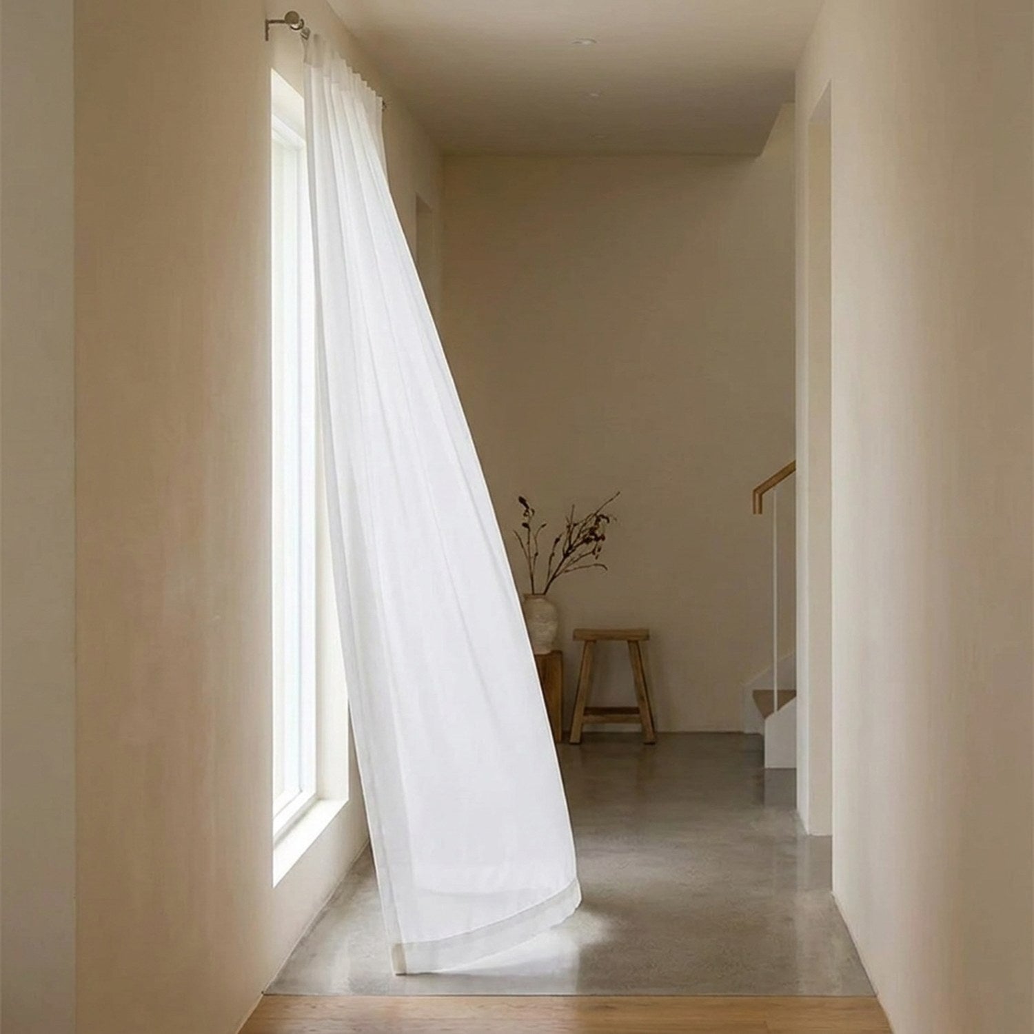 Voilage blanc mousseline taille 100 x 250 cm devant une fenêtre étroite d'un couloir lumineux
