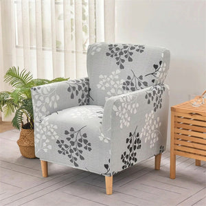 Fauteuil club housse motif branchages sur fond gris clair