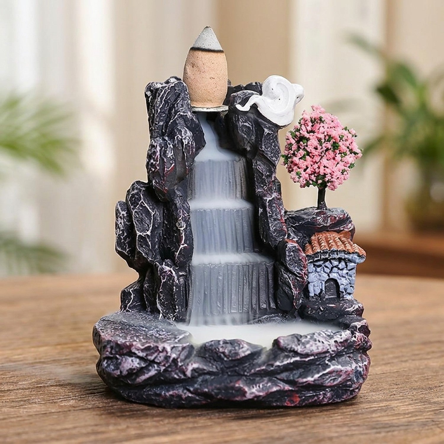 Brûleur d'encens à reflux modèle cerisier rose avec cascade fumante sur table en bois