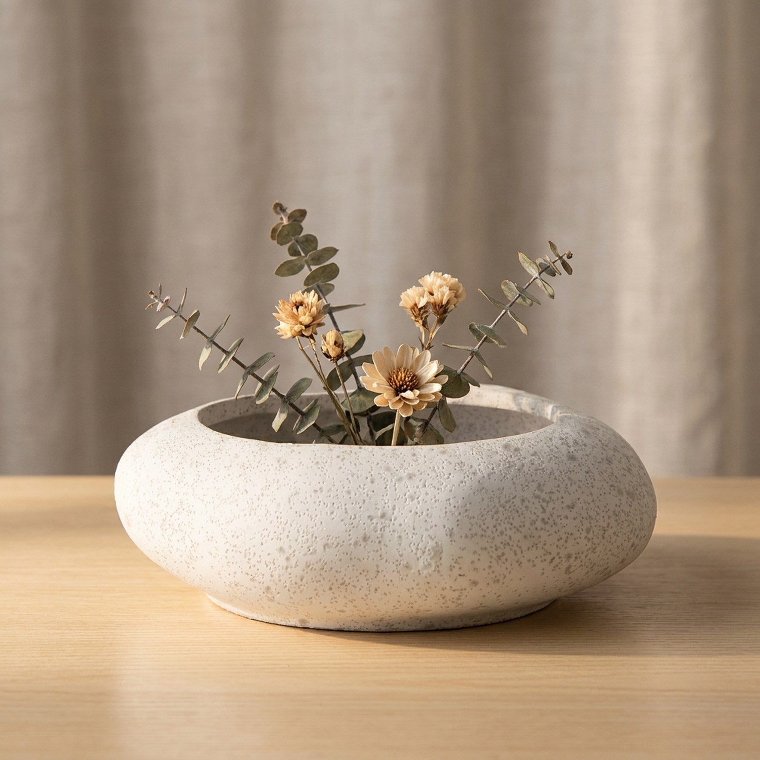 Vase galet en céramique blanche avec fleurs séchées