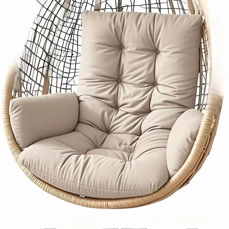Coussin fauteuil moderne capitonné avec accoudoir, doté d’un dossier haut et d’accoudoirs rembourrés, installé sur un fauteuil suspendu pour une assise confortable et élégante.