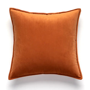 Coussin terracotta style rétro avec capitonnage posé sur fond clair, accompagné d’une vue arrière carrée au tissu terracotta doux.