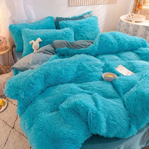 Une parure de lit cocooning ultra moelleuse à texture pelucheuse, présentée en plusieurs couleurs vives comme rouge, vert et bleu, recouvrant un lit volumineux et invitant dans une chambre chaleureuse.