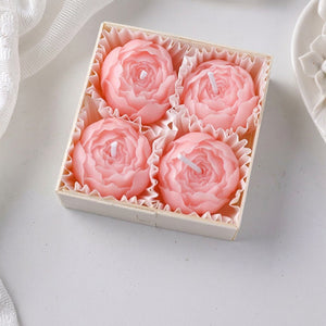 Coffret de quatre bougies parfumées en forme de rose rose