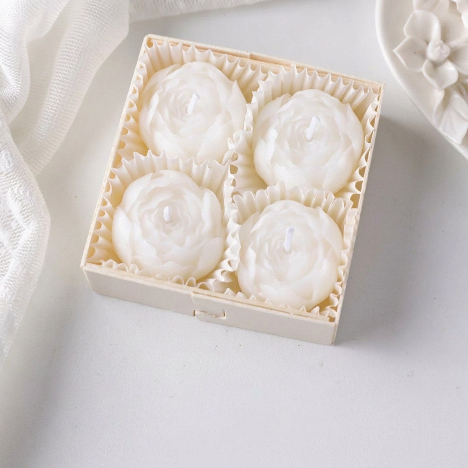 Coffret de quatre bougies parfumées en forme de rose blanche