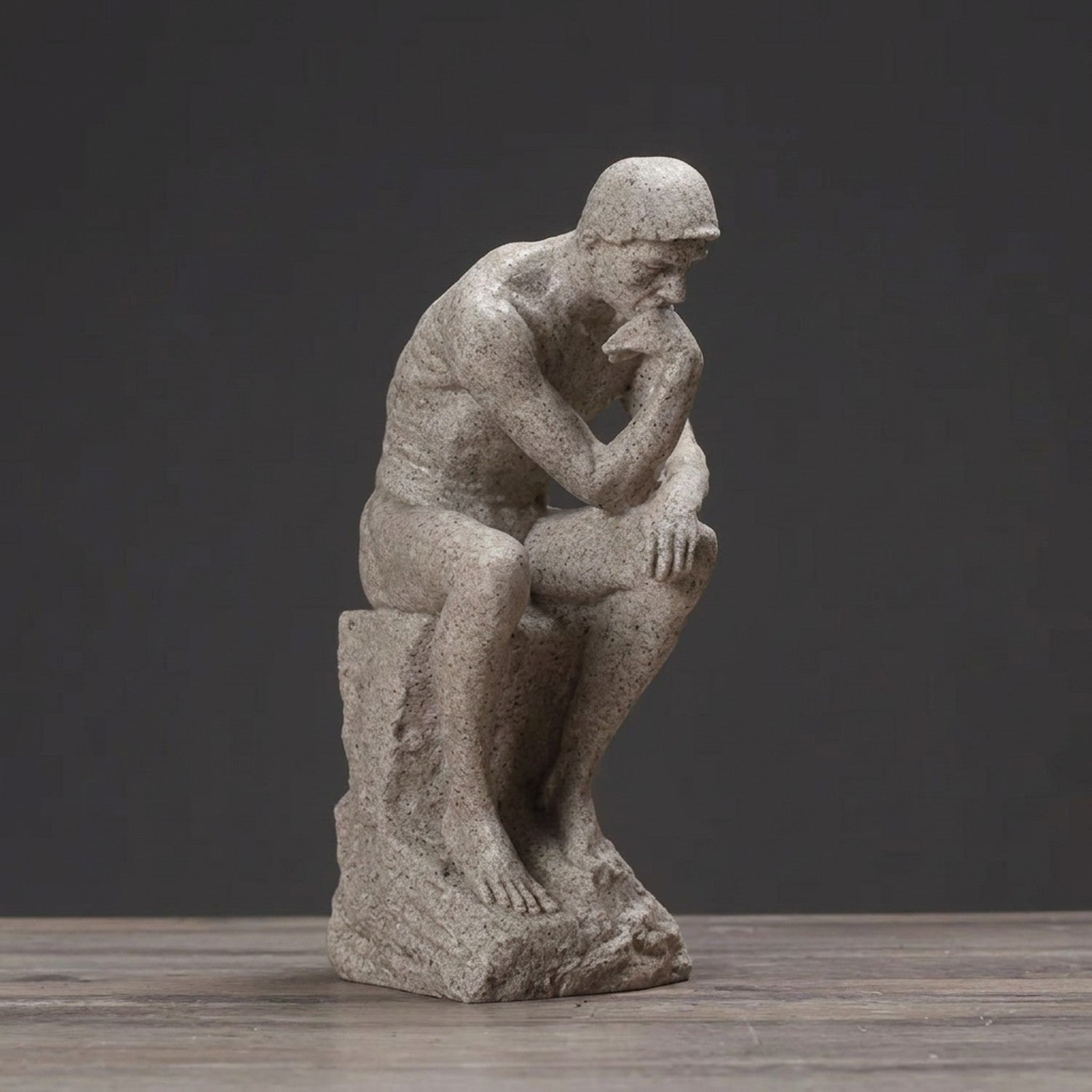 Photo produit statue de penseur en résine beige vue de face sur fond gris