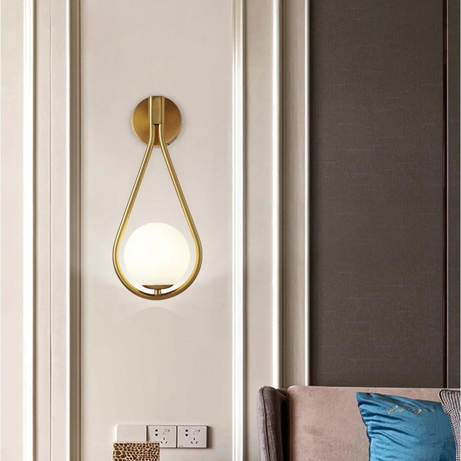 Applique murale dorée boule de verre dans un salon moderne