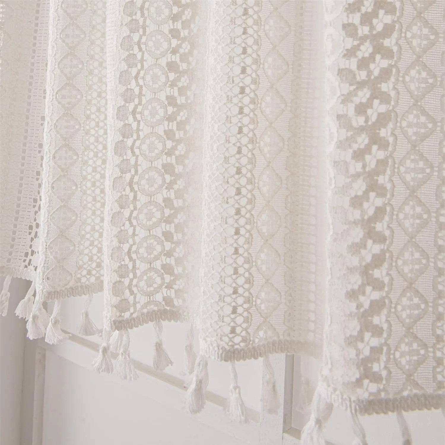 Détail des motifs de dentelle et de la bordure à glands