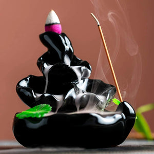 Cascade de fumée d'encens sur brûleur céramique artisanale fond sombre