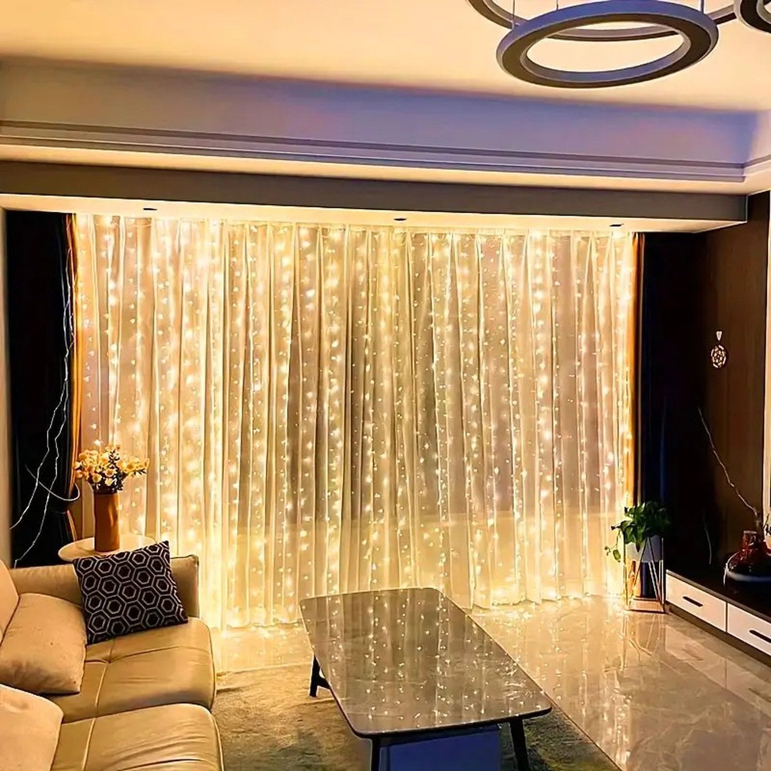 Rideau lumineux LED doré dans un salon cosy avec canapé et vase de fleurs