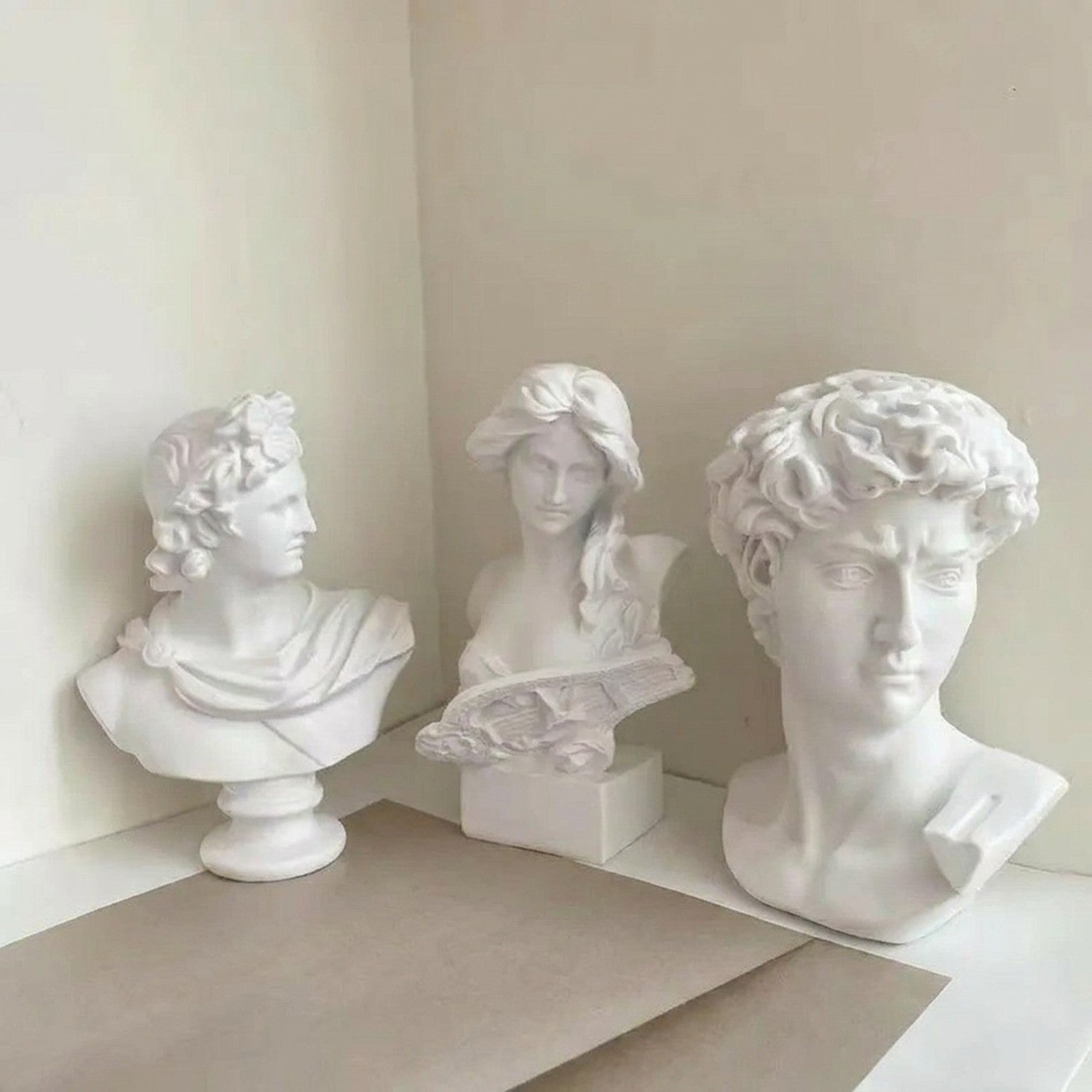 Trois bustes en résine dans un décor artistique contemporain