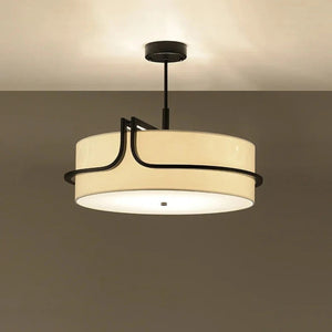 Lustre en tissu crème fixé au plafond avec sa vague de métal noir