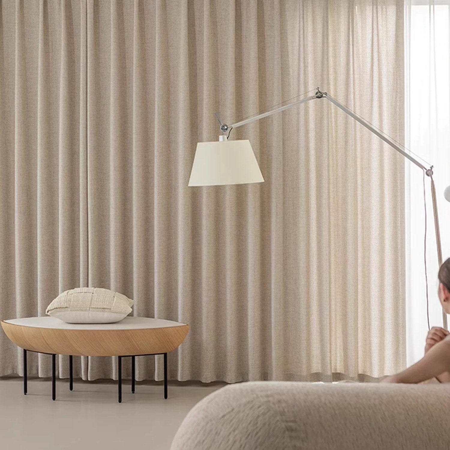 Voilage aspect lin naturel suspendu du sol au plafond dans un salon épuré
