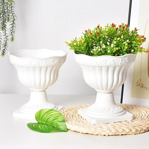 Cache-pot sur pied colonne romaine blanc avec du feuillage