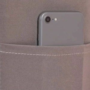Poche latérale de la housse de tête de lit avec un téléphone glissé dedans