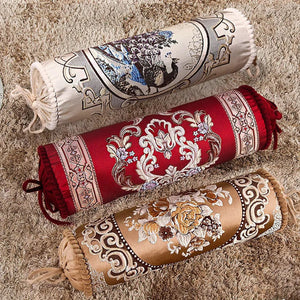Trois housses de traversin cylindriques brodées de motifs baroques