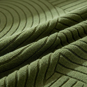 Détail tissu vert foncé motif géométrique