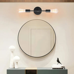 Applique murale noire au-dessus d'un meuble avec miroir rond en salle de bain