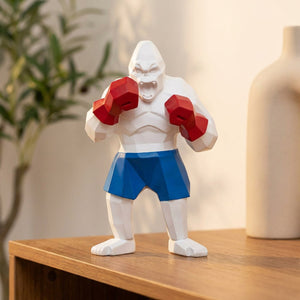 Statue gorille boxeur blanc aux gants rouges et short bleu en résine