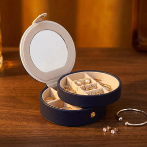Boîte à bijoux ronde en cuir bleu marine ouverte avec miroir intégré