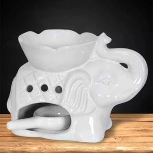 Brûle-parfum céramique éléphant blanc vu de profil sur fond sombre