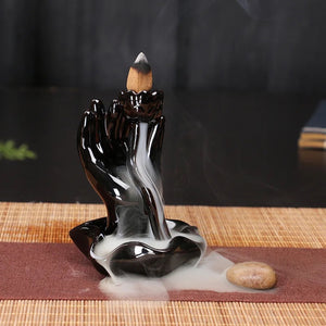 Brûleur encens refoulement céramique noir main de Bouddha