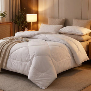 Couette en laine blanche ouverte sur un lit dans une chambre cocooning éclairée par une lampe