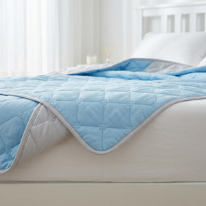 Détail de la couette d'été réversible bleue et grise au matelassage fleur délicat