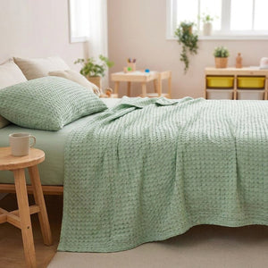 Couverture bambou verte nid d'abeille dans une chambre enfant lumineuse