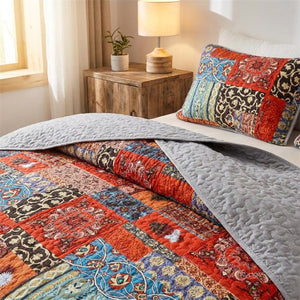 Couvre-lit bohème réversible montrant l envers gris matelassé replié sur le lit