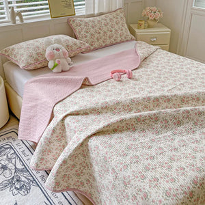 Coin replié du couvre-lit matelassé montrant la doublure rose unie
