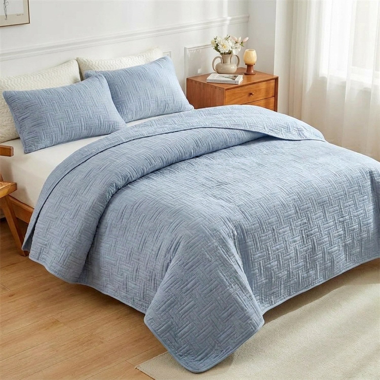 Couvre-lit matelassé bleu gris à motif de tissage géométrique sur un lit