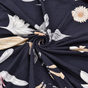 Gros plan sur le tissu extensible imprimé floral bleu marine de la housse de fauteuil