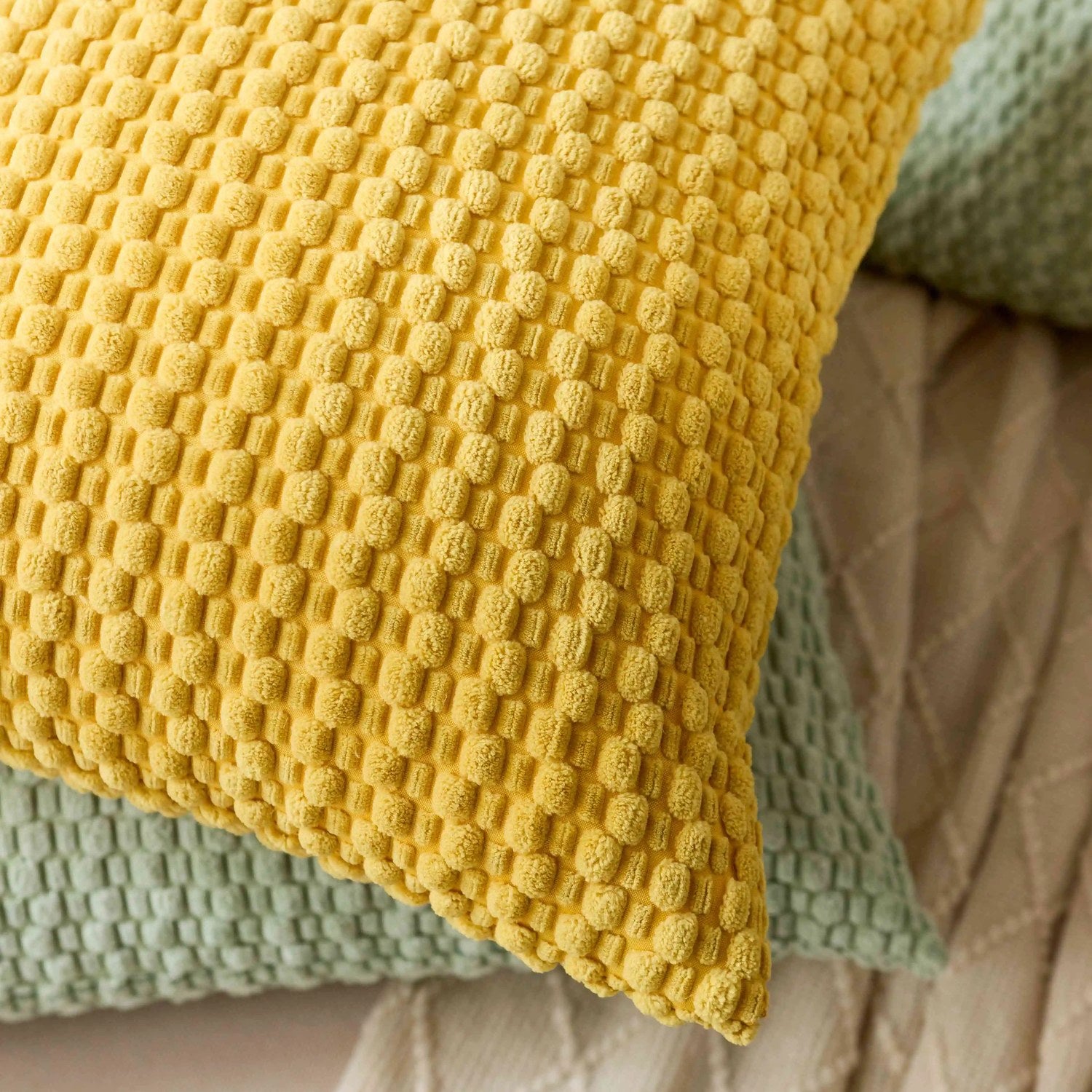 gros plan sur la maille texturée en relief de la housse de coussin