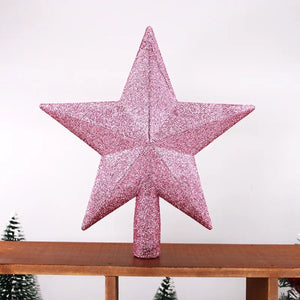 Étoile de sapin pailletée rose gros plan sur surface en bois