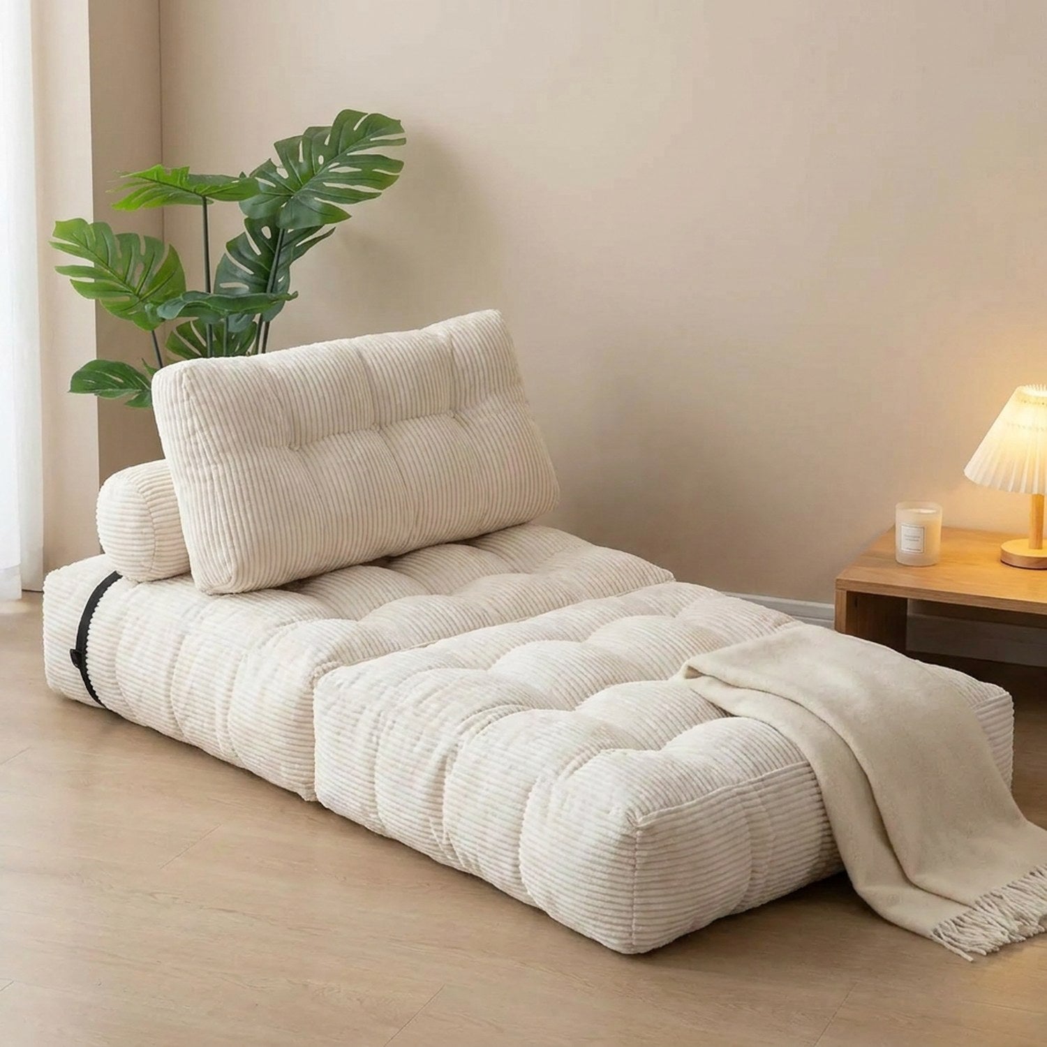 Chaise convertible dépliée en lit d'appoint blanc dans une chambre épurée