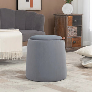 Pouf coffre de rangement gris dans un salon avec fauteuil et commode bois