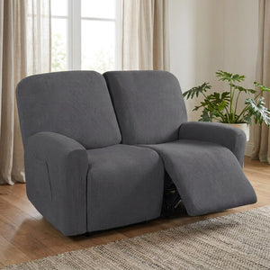 Housse de canapé relax grise sur un canapé inclinable deux places dans un salon lumineux