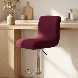 Housse de chaise de bar en jacquard texturé coloris grenat sur un tabouret