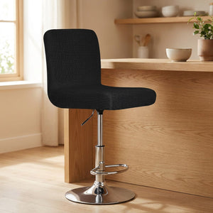 Housse de chaise de bar en jacquard texturé coloris noir sur un tabouret