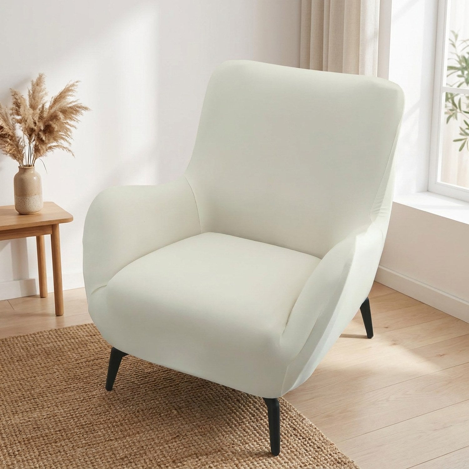 Housse de fauteuil extensible écru dans un salon scandinave lumineux