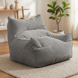 Fauteuil poire une place en coton gaufré gris dans un coin détente