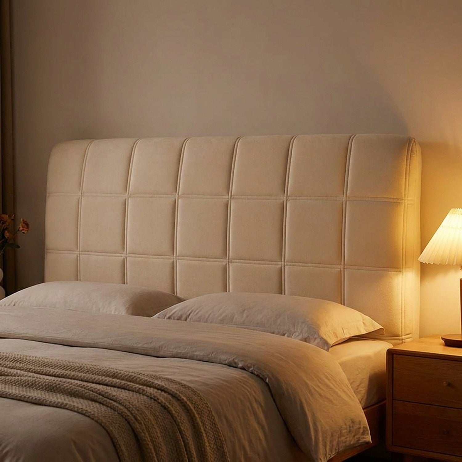 Housse de tête de lit beige matelassée en ambiance chaleureuse de soirée