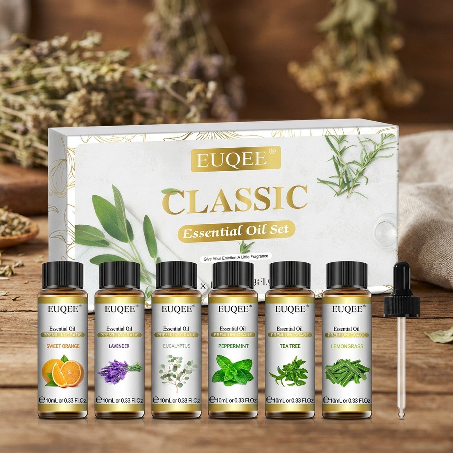 Coffret de six huiles essentielles EUQEE avec compte-gouttes posé sur une table en bois
