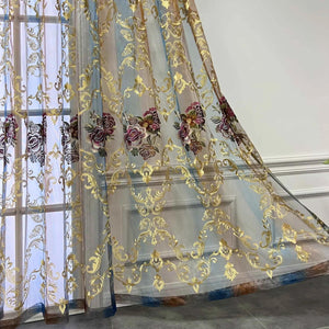 Rideau voilage tulle drapé devant une porte vitrée avec broderie florale dorée